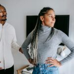 man explaining himself to disappointed woman